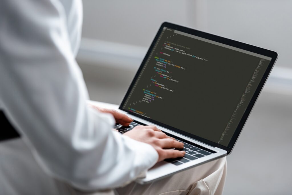 cropped view of woman using laptop with microsoft windows on screen